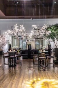 Luxurious banquet hall setup with elegant floral decor and stylish lighting.